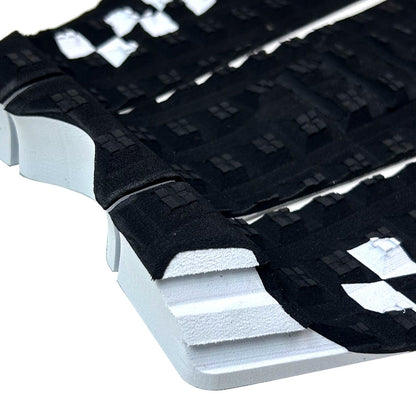 Detail of Shapers Sheldon Simkus black 3pc surfboard traction pad